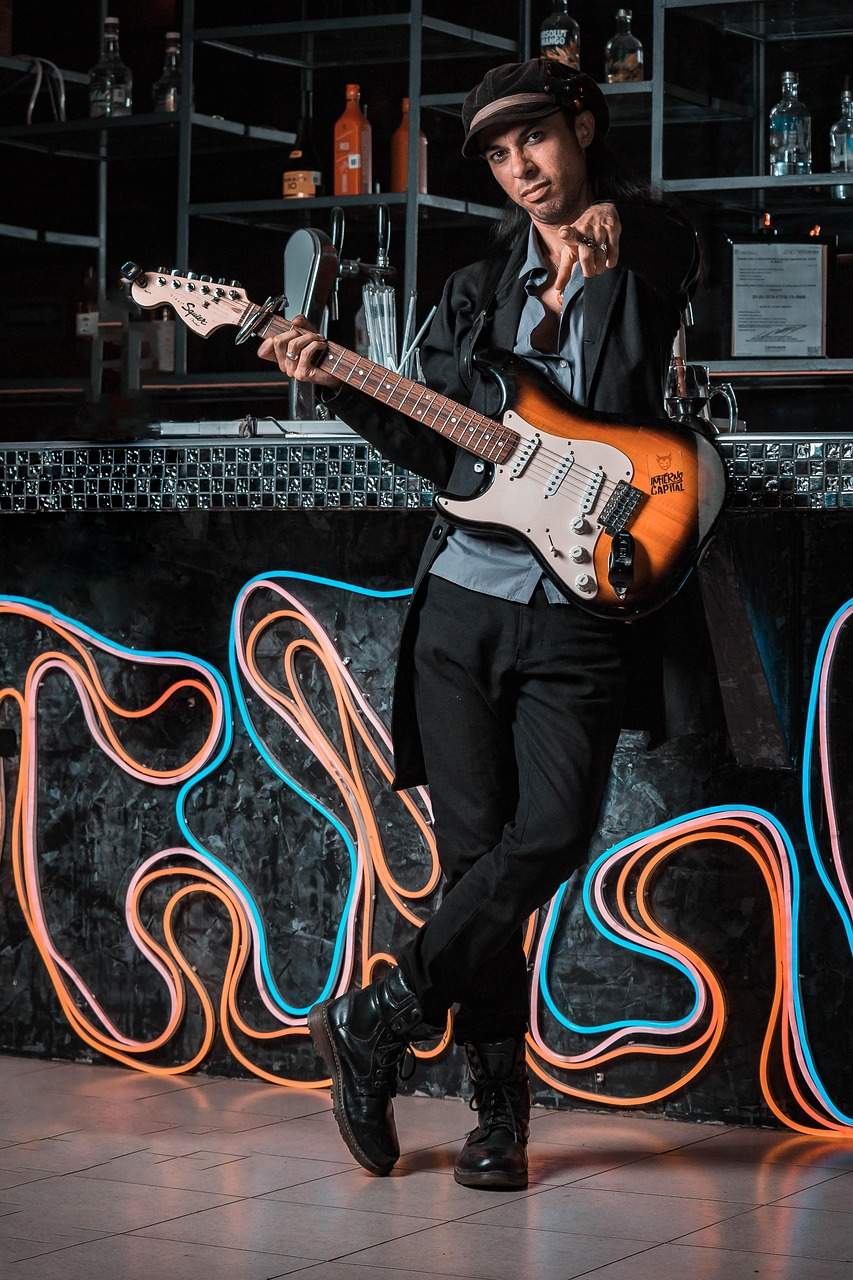 man holding a guitar - tactics from the music industry to boost PR